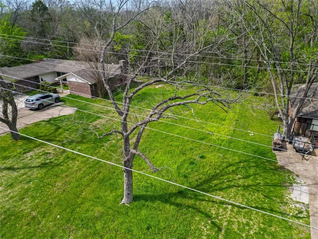 a backyard of a house with lots of green space and outdoor seating