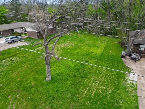 a backyard of a house with lots of green space and a fountain