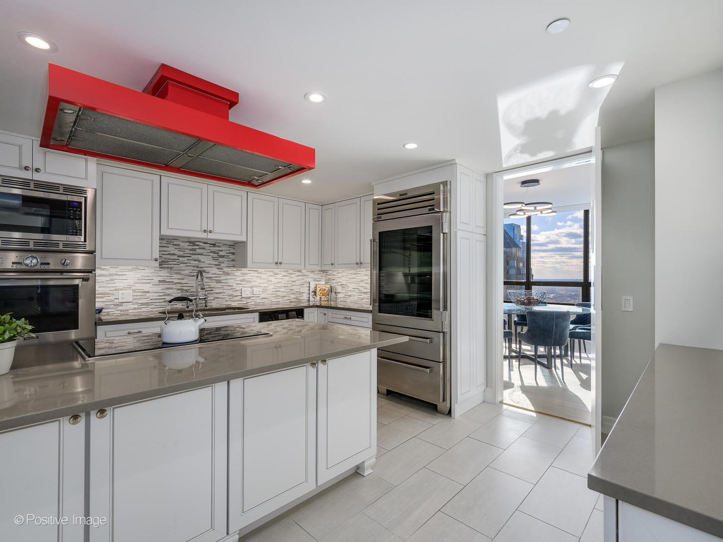180 East Pearson Street, Unit 6501 Chicago, IL 60611 - Photo 12 of 35 a kitchen with stainless steel appliances kitchen island granite countertop a sink and cabinets