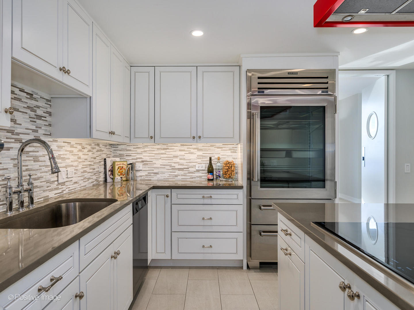 180 East Pearson Street, Unit 6501 Chicago, IL 60611 - Photo 14 of 35 a kitchen with granite countertop a sink stainless steel appliances and cabinets