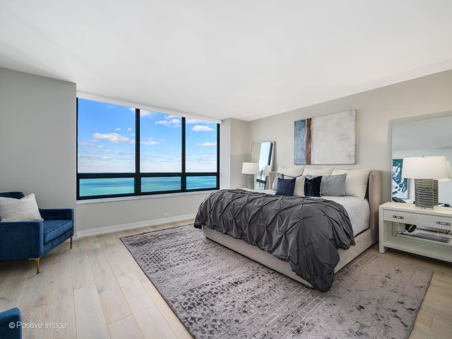 180 East Pearson Street, Unit 6501 Chicago, IL 60611 - Photo 19 of 35 a spacious bedroom with a large bed and a large window