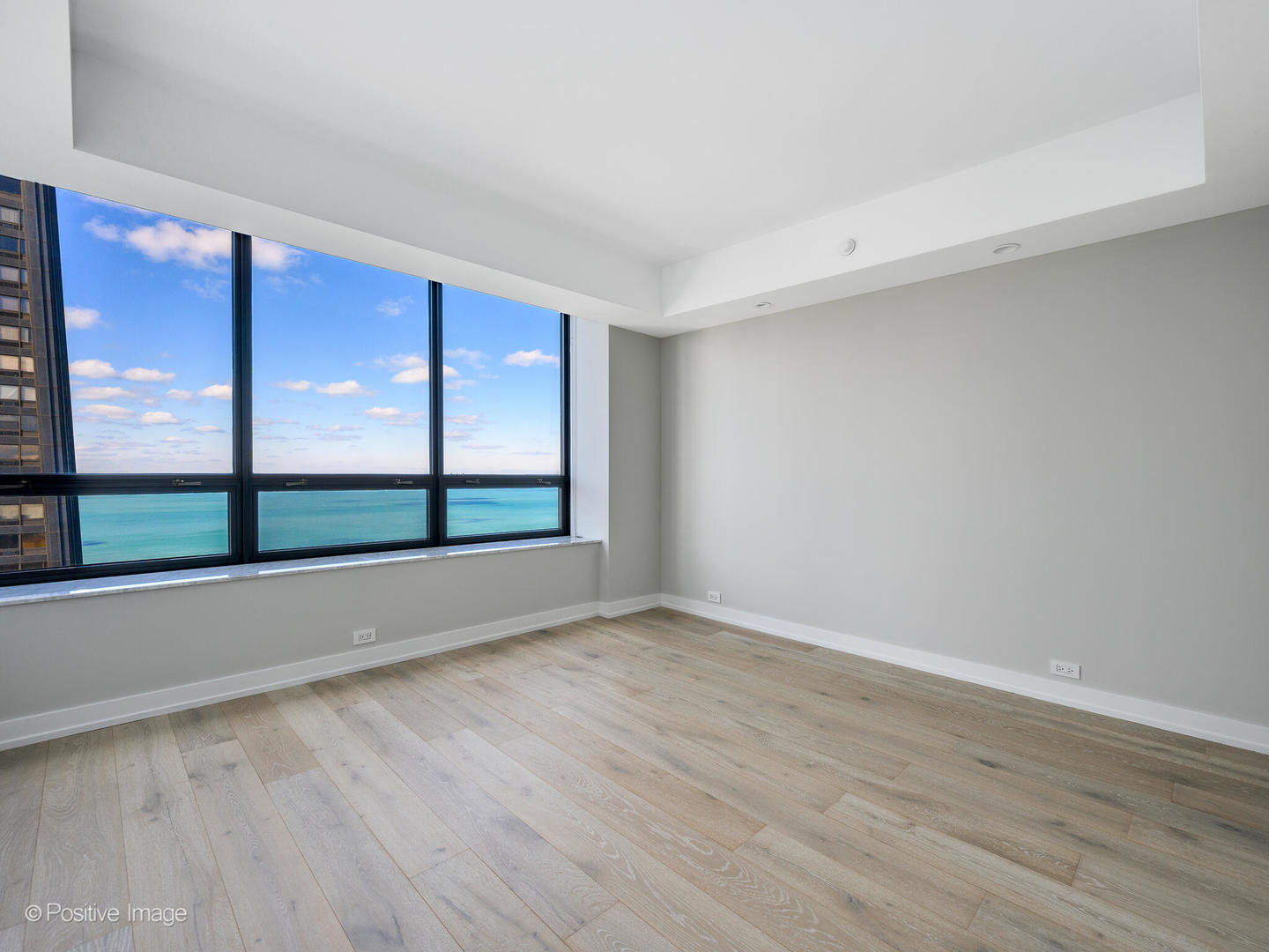 180 East Pearson Street, Unit 6501 Chicago, IL 60611 - Photo 26 of 35 a view of an empty room with wooden floor and windows