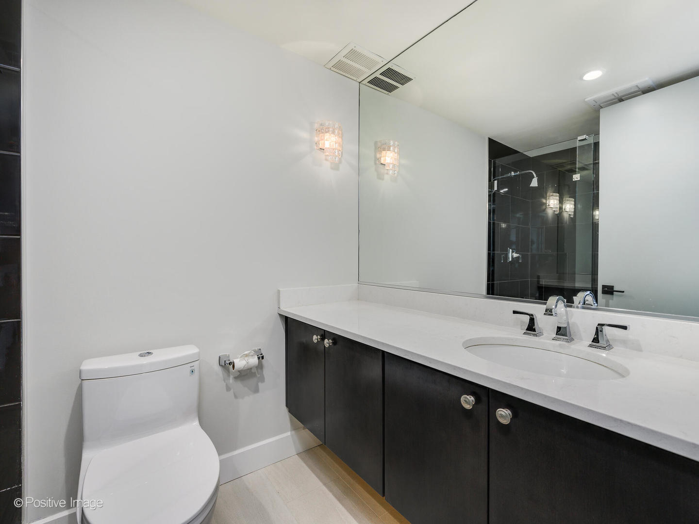 180 East Pearson Street, Unit 6501 Chicago, IL 60611 - Photo 27 of 35 a bathroom with a toilet sink and mirror