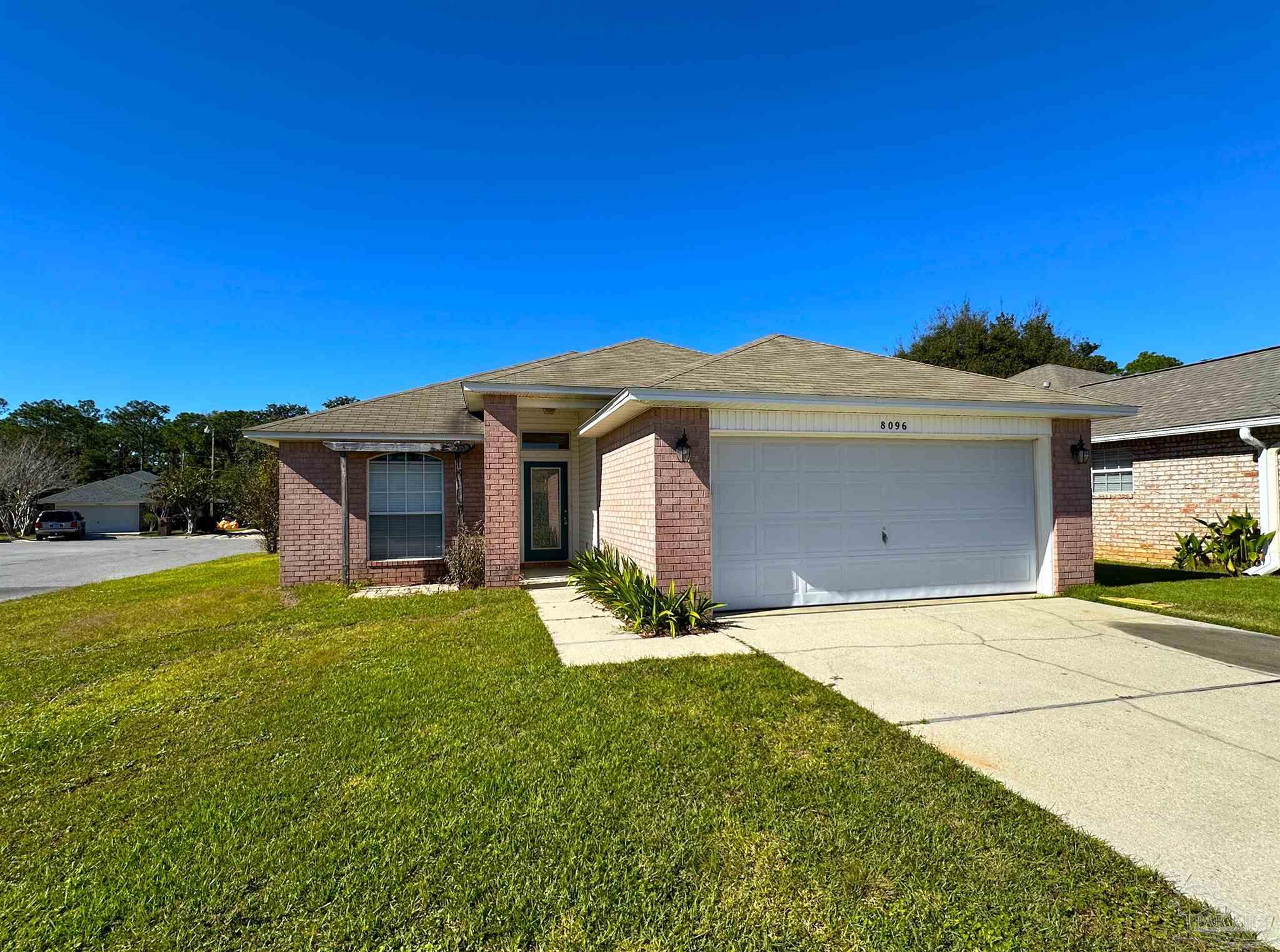 a view of a house with a yard and garage