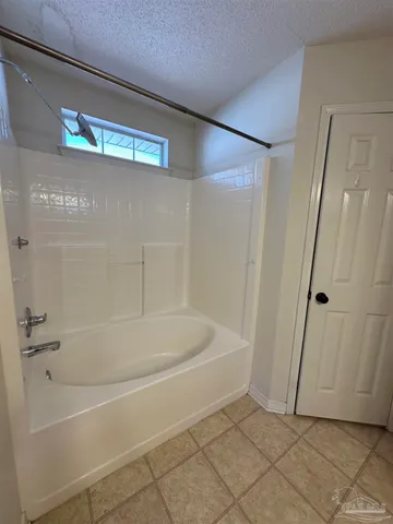 a view of a room with windows and chandelier fan