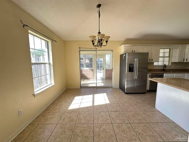 a large kitchen with stainless steel appliances granite countertop a refrigerator a sink and a stove