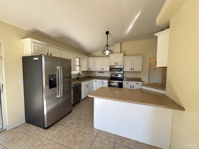 a view of an empty room and wooden floor