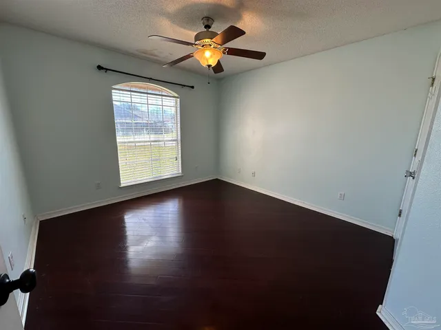 a view of room with window and ceiling fan