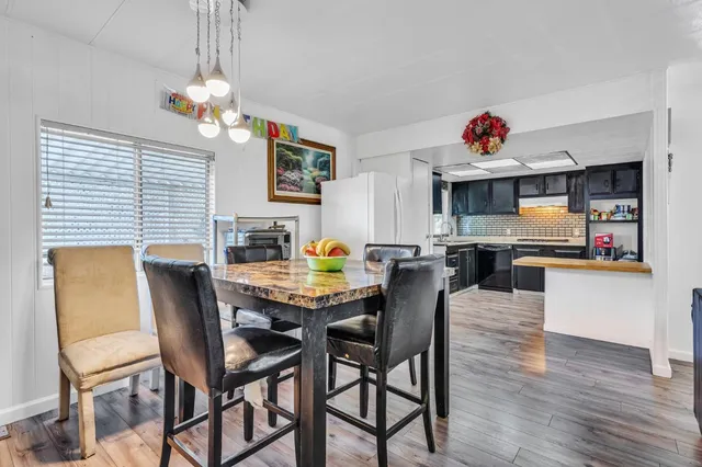 a view of a dining room with furniture and wooden floor