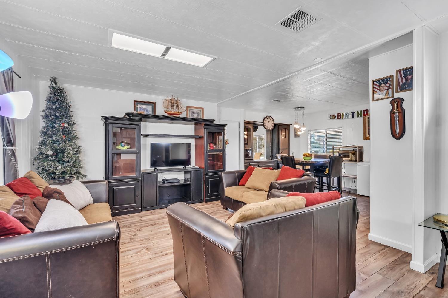 3950 Mack Road, Unit 169 Sacramento, CA 95823 - Photo 2 of 10 a living room with furniture and a flat screen tv