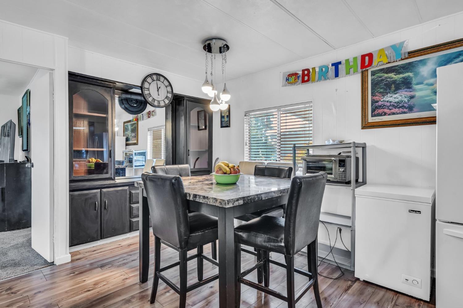 3950 Mack Road, Unit 169 Sacramento, CA 95823 - Photo 3 of 10 a view of a dining room with furniture window and wooden floor