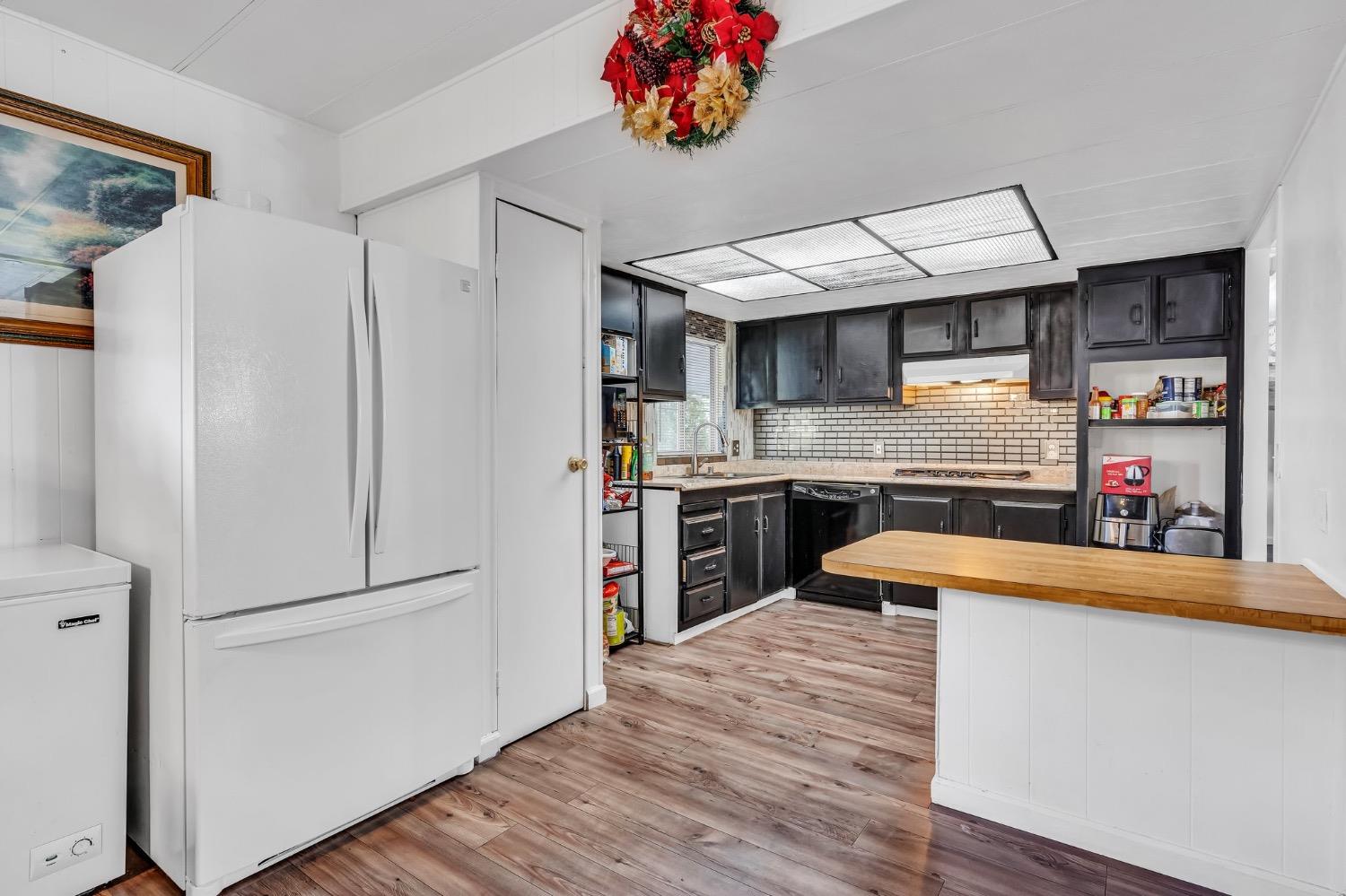 3950 Mack Road, Unit 169 Sacramento, CA 95823 - Photo 4 of 10 a kitchen with stainless steel appliances granite countertop a refrigerator a sink dishwasher a stove and a refrigerator