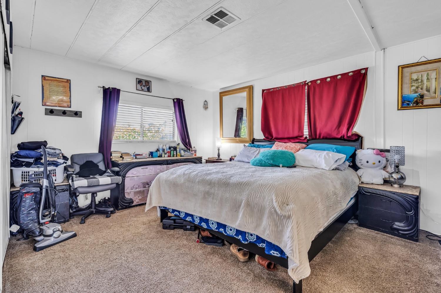 3950 Mack Road, Unit 169 Sacramento, CA 95823 - Photo 5 of 10 a bedroom with a bed mirror and window