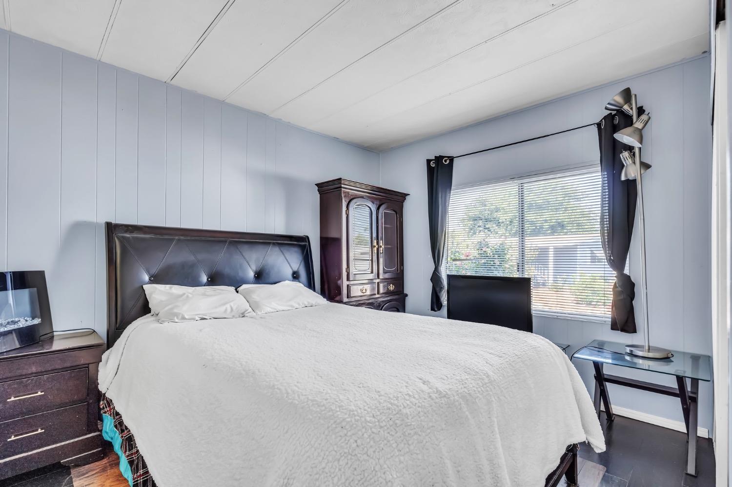3950 Mack Road, Unit 169 Sacramento, CA 95823 - Photo 8 of 10 a bedroom with a large bed and a large window