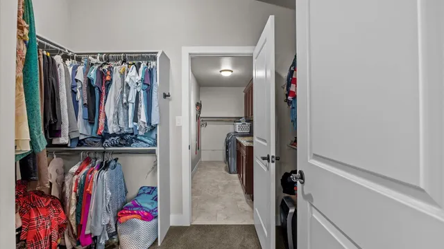 a view of walk in closet with clothes