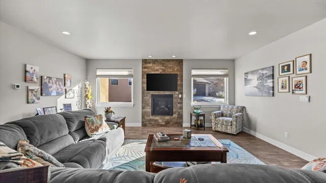 a living room with furniture flat screen tv and a fireplace
