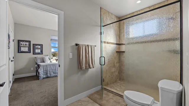 a bathroom with a toilet and a shower