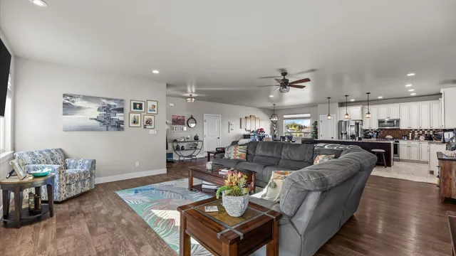 a living room with furniture kitchen view and a table