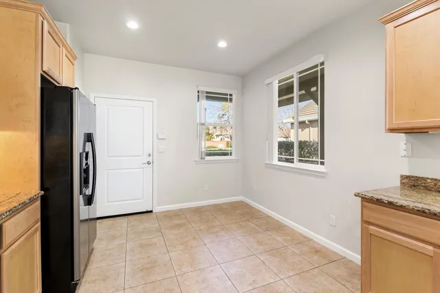a view of a kitchen with a sink and a refrigerator