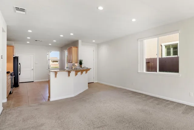 a view of a big room with white walls and windows