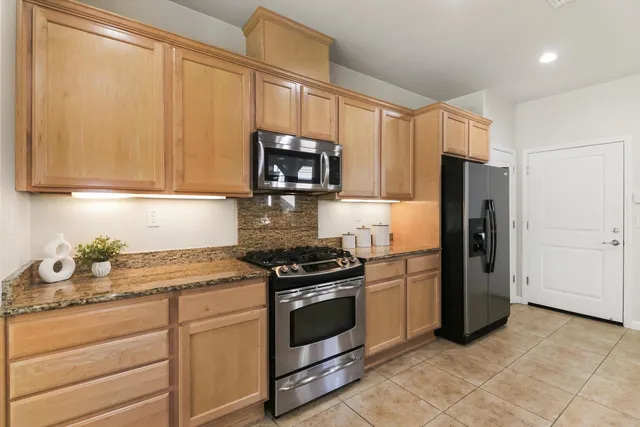 a kitchen with a refrigerator stove and microwave