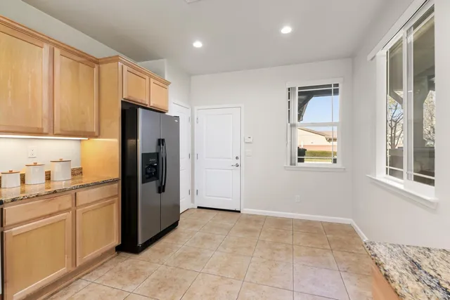a kitchen with stainless steel appliances a refrigerator and a stove top oven
