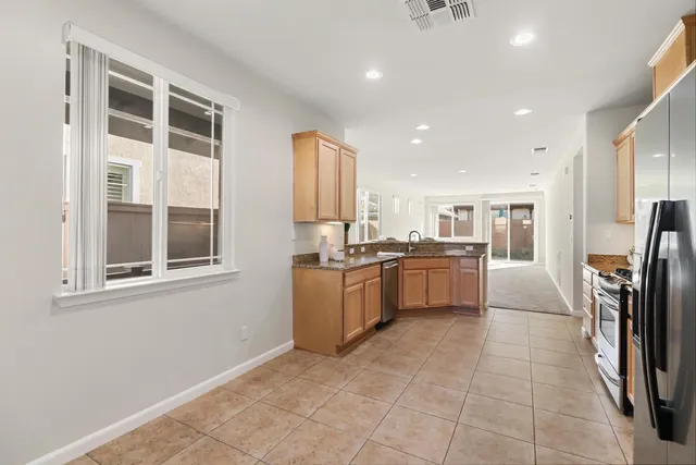 a kitchen with a refrigerator and a sink