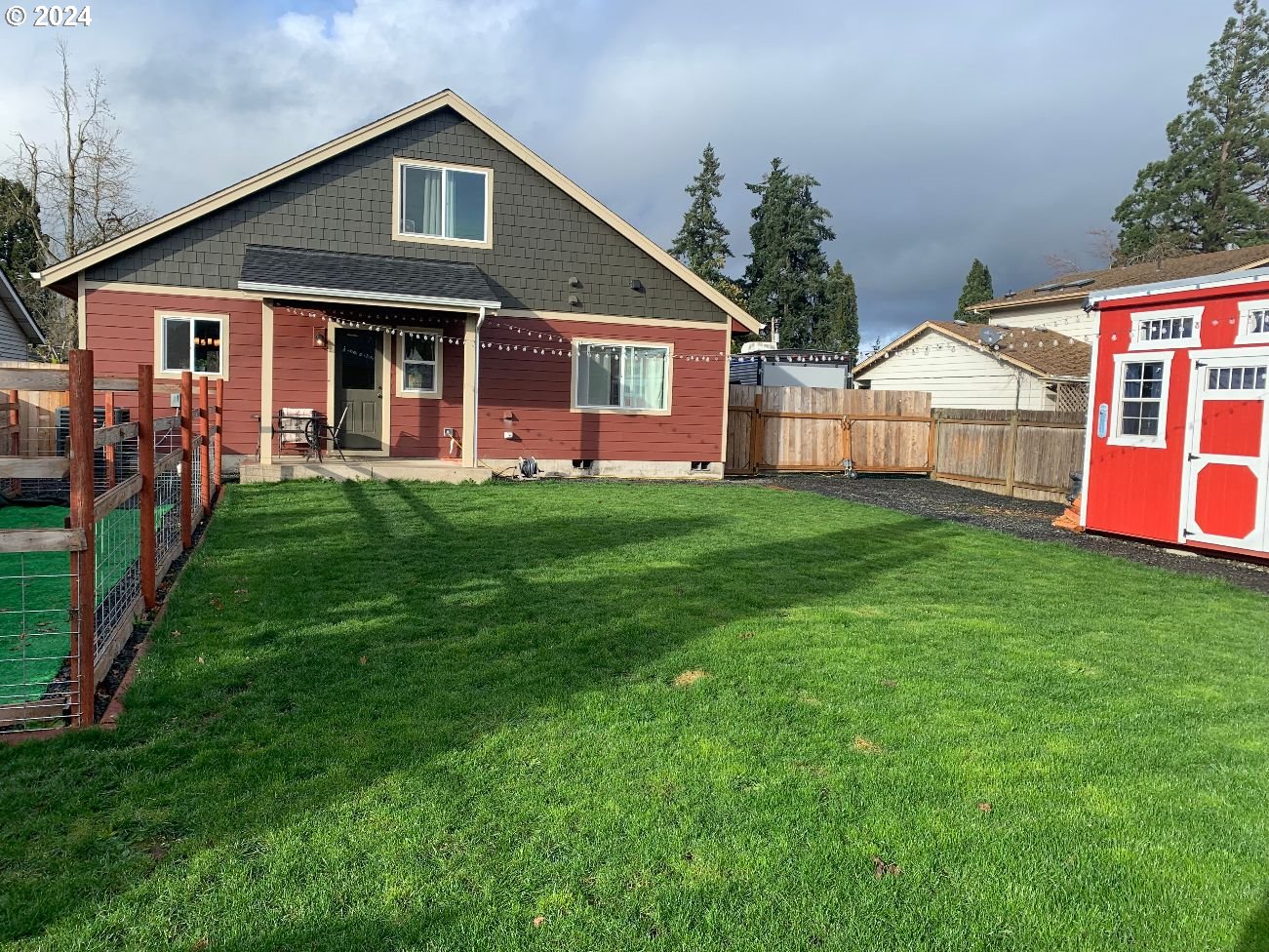 1265 F Street Springfield, OR 97477 - Photo 14 of 32 a front view of a house with a yard and trees