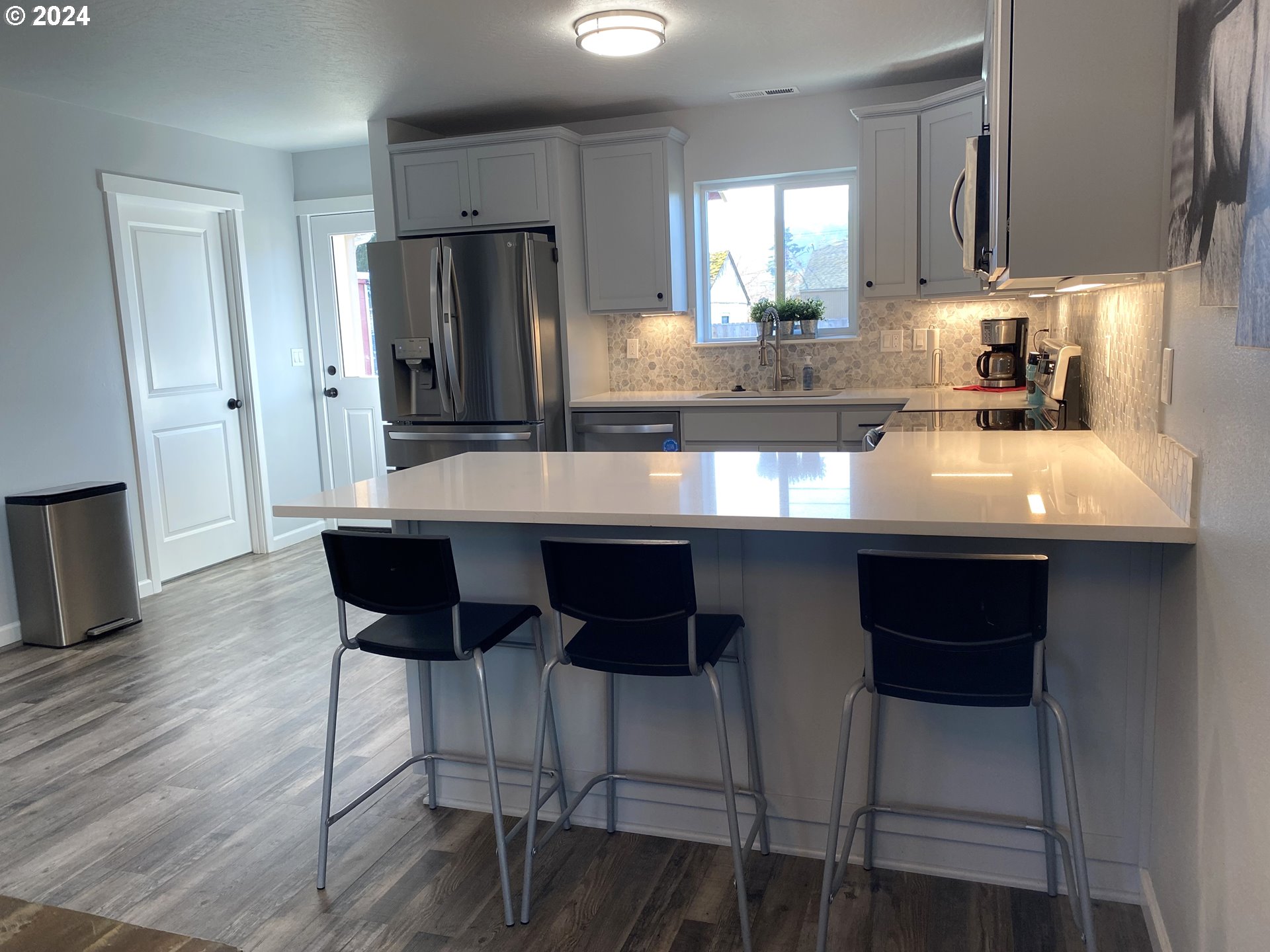 1265 F Street Springfield, OR 97477 - Photo 20 of 32 a kitchen with stainless steel appliances granite countertop a table chairs refrigerator and sink