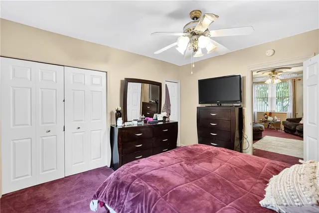 a spacious bedroom with a bed and a dresser