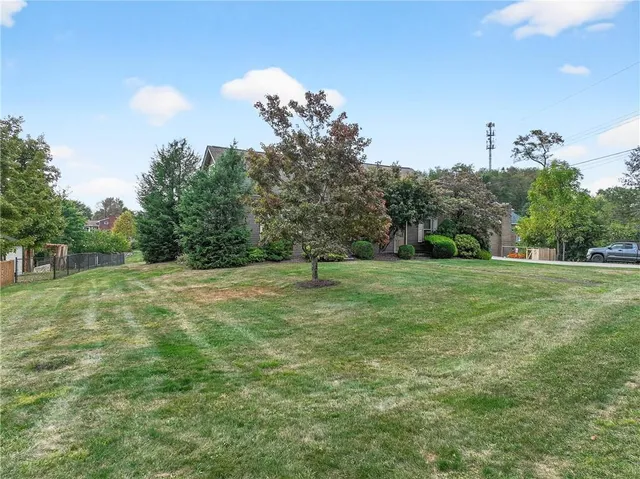 a view of a house with yard and a garden