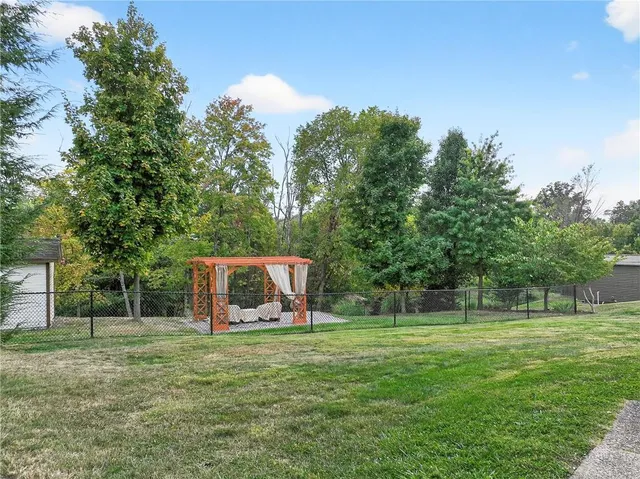 a backyard of a house with plants and tree