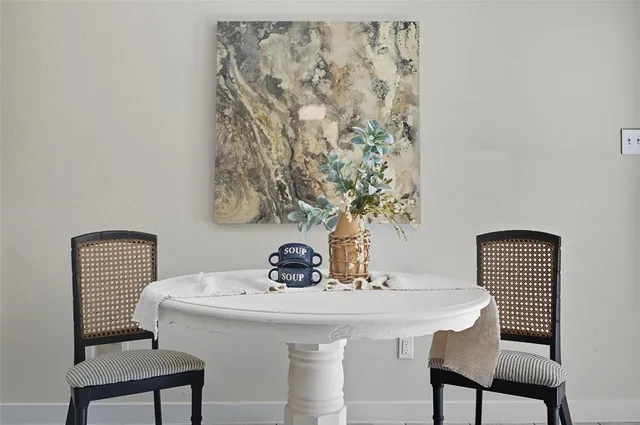 a dining room with furniture and window