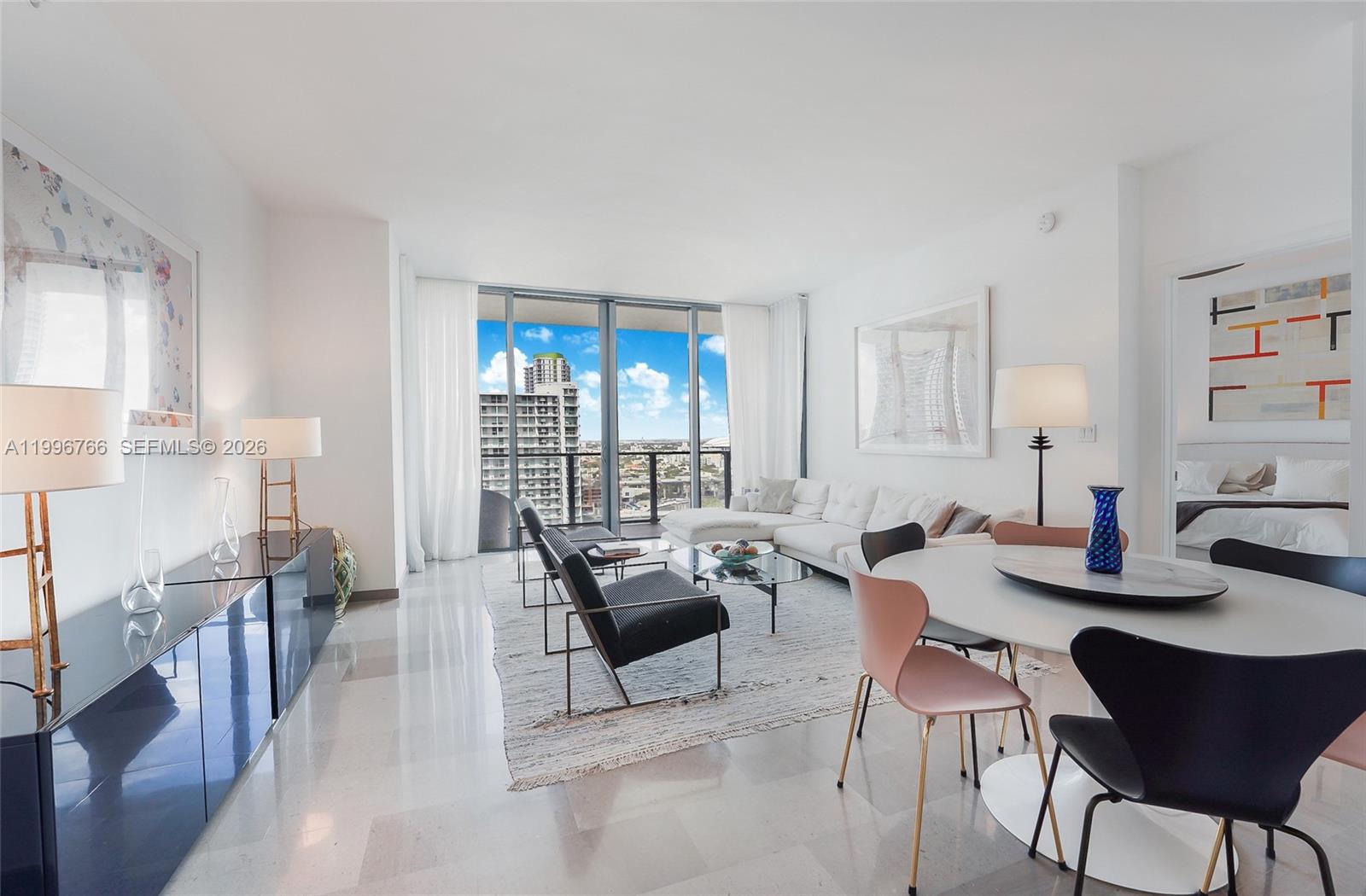 68 Southeast 6th Street, Unit 2104 Miami, FL 33131 - Photo 2 of 33 a living room with furniture and a wooden floor