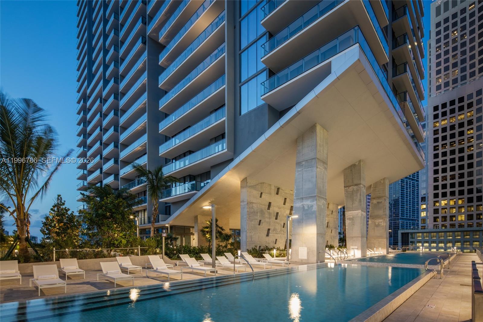 68 Southeast 6th Street, Unit 2104 Miami, FL 33131 - Photo 22 of 33 a view of swimming pool with outdoor seating and house in the background