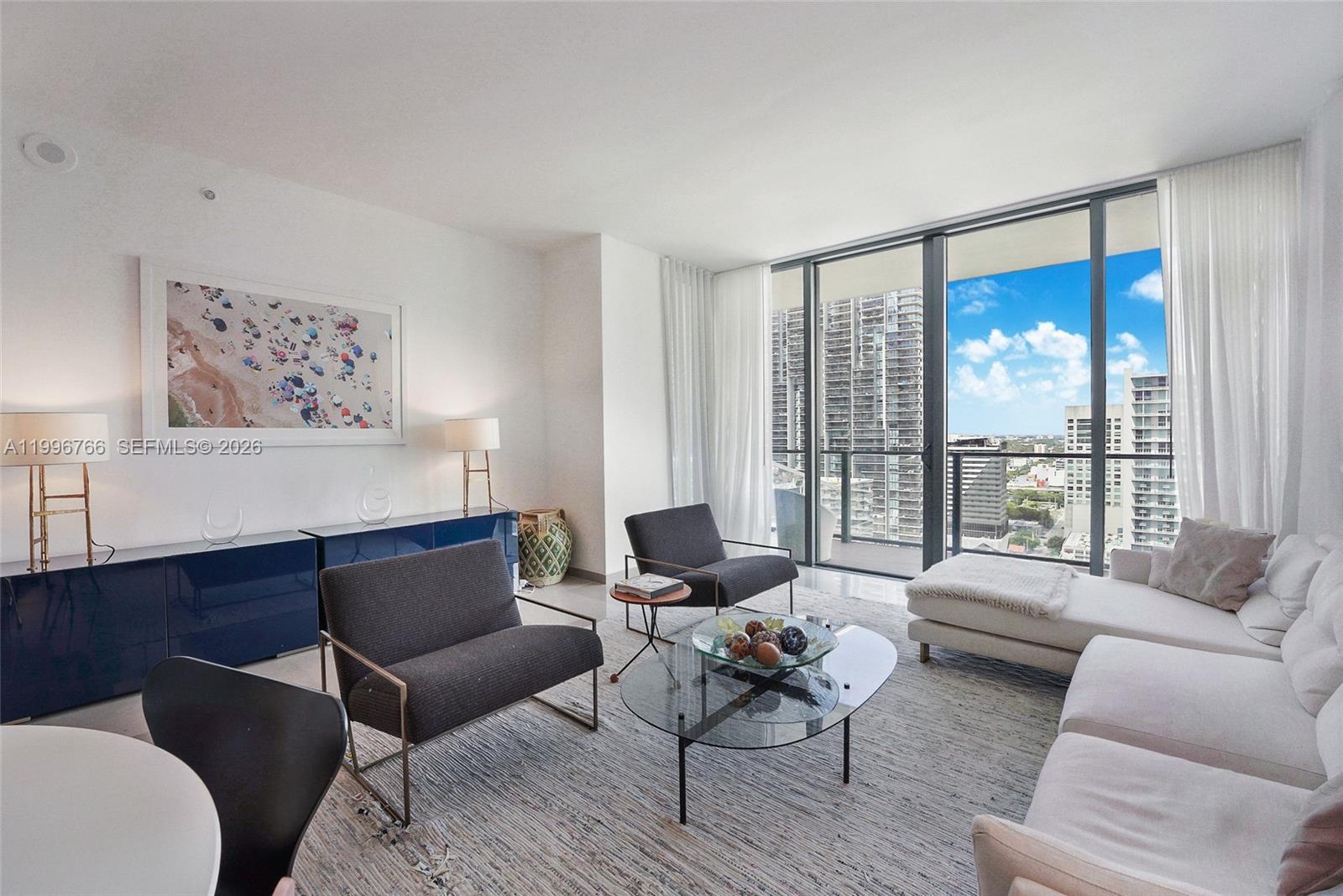 68 Southeast 6th Street, Unit 2104 Miami, FL 33131 - Photo 3 of 33 a living room with furniture and a large window