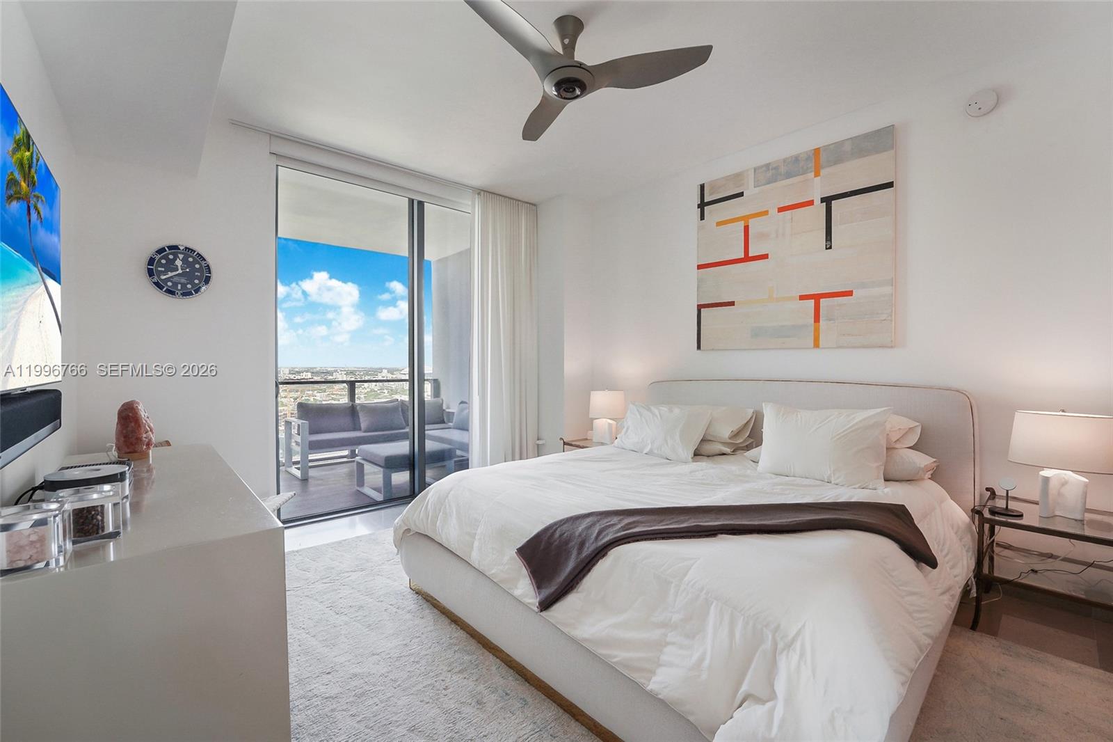 68 Southeast 6th Street, Unit 2104 Miami, FL 33131 - Photo 9 of 33 a bedroom with a bed couch and a window