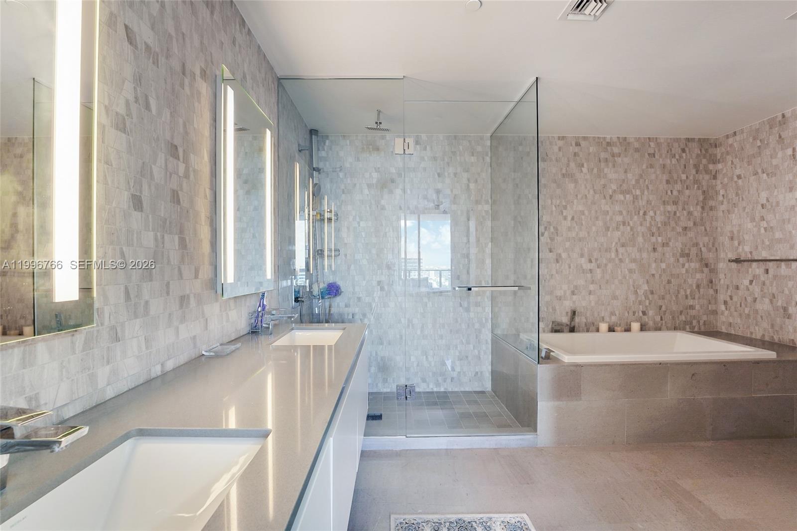 68 Southeast 6th Street, Unit 2104 Miami, FL 33131 - Photo 10 of 33 a bathroom with a bathtub and a sink