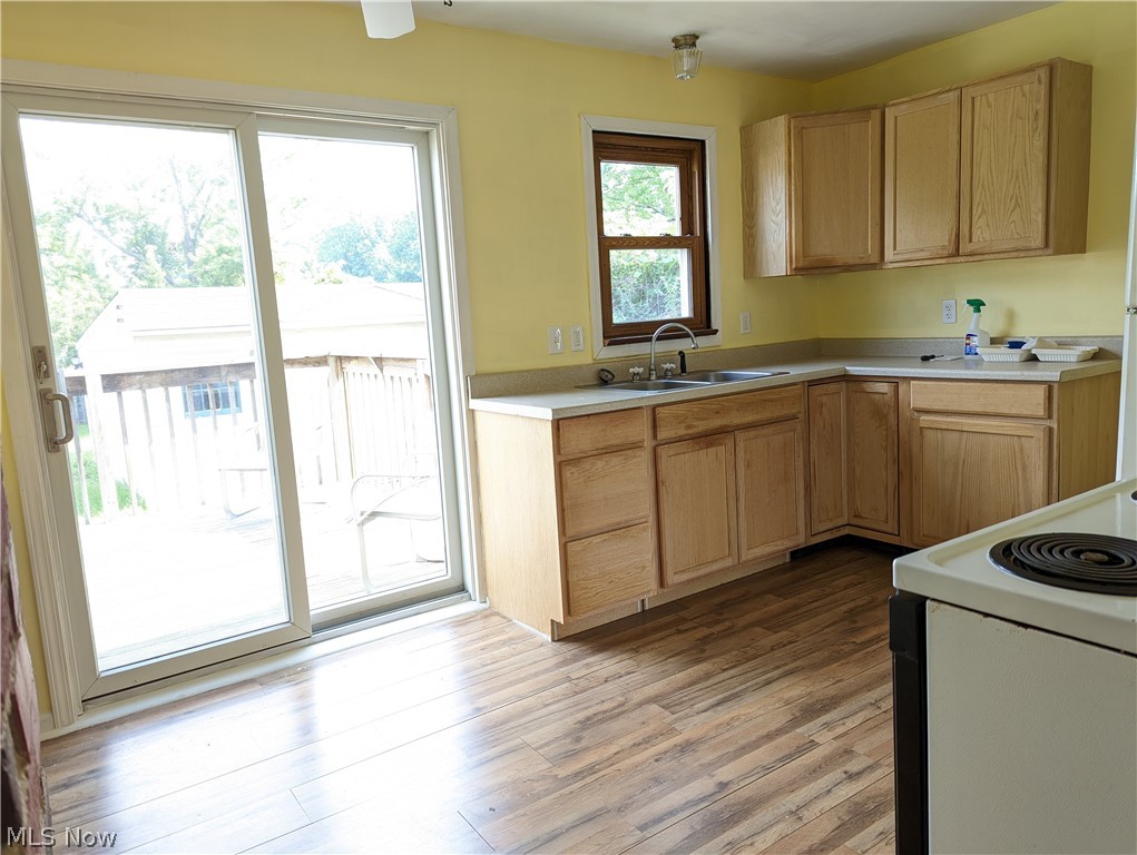 13817 Granger Road Cleveland, OH 44125 - Photo 6 of 22 Kitchen with new cabinets. Also has patio door leading to deck and deep fenced-in back yard.