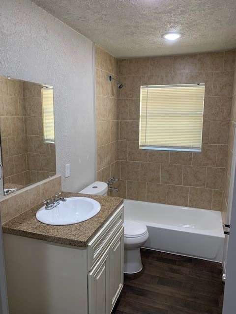 3107 Friar Point Road Houston, TX 77051 - Photo 7 of 9 a bathroom with a granite countertop sink a toilet a mirror and bathtub