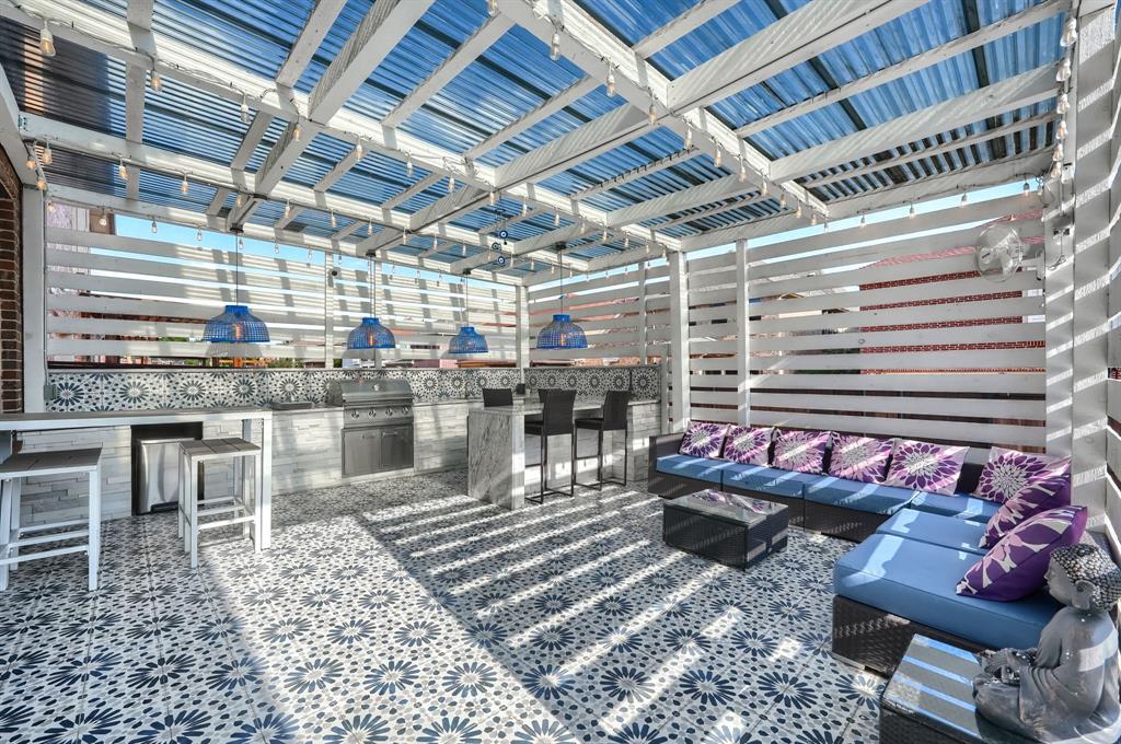 2246 Longview Road Irving, TX 75063 - Photo 36 of 40 Rooftop patio with patterned tile flooring, a slatted pergola roof, and a built-in outdoor kitchen featuring a grill and beverage refrigerator