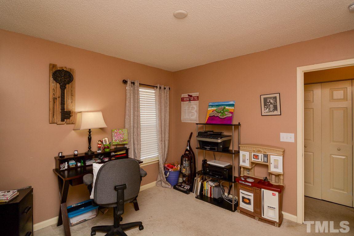 3677 Marshlane Way Raleigh, NC 27610 - Photo 17 of 24 a room with furniture and gym equipment