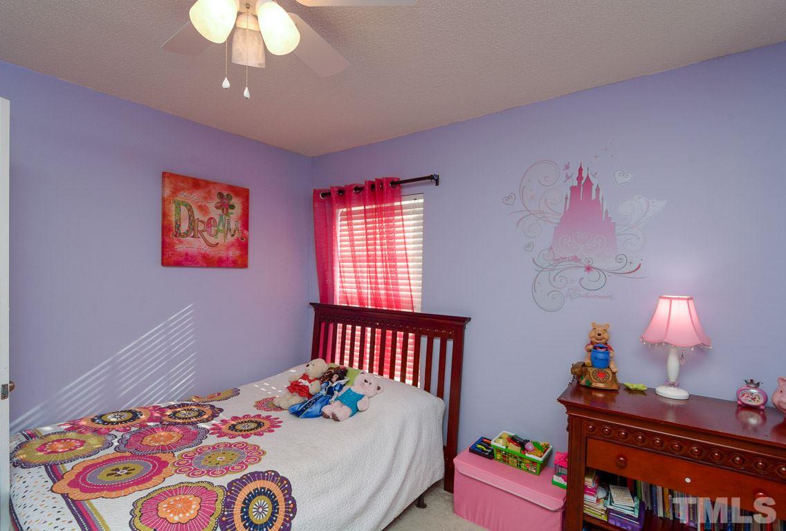 3677 Marshlane Way Raleigh, NC 27610 - Photo 21 of 24 a bedroom with a bed and dresser
