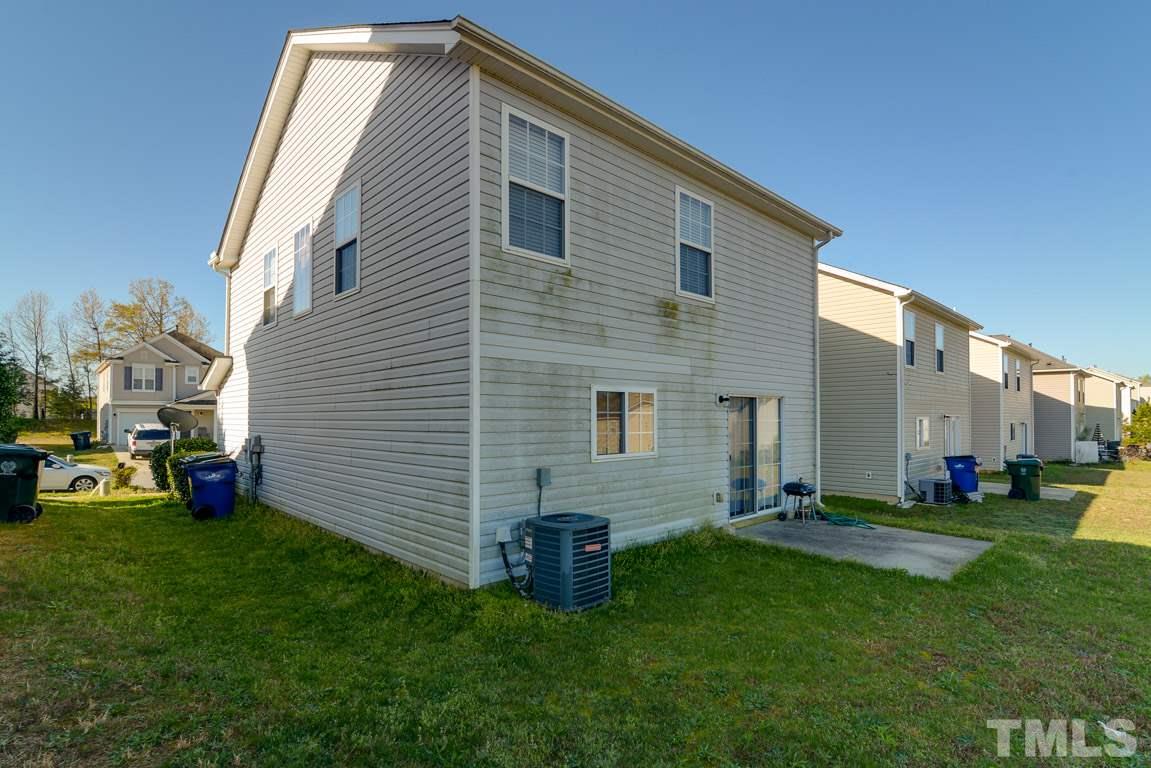 3677 Marshlane Way Raleigh, NC 27610 - Photo 22 of 24 a front view of a house with a garden