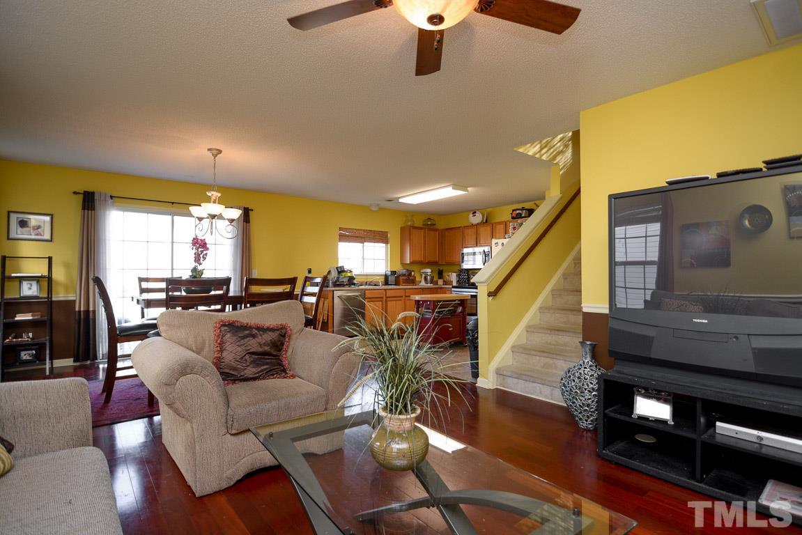 3677 Marshlane Way Raleigh, NC 27610 - Photo 6 of 24 a living room with furniture kitchen view and a wooden floor
