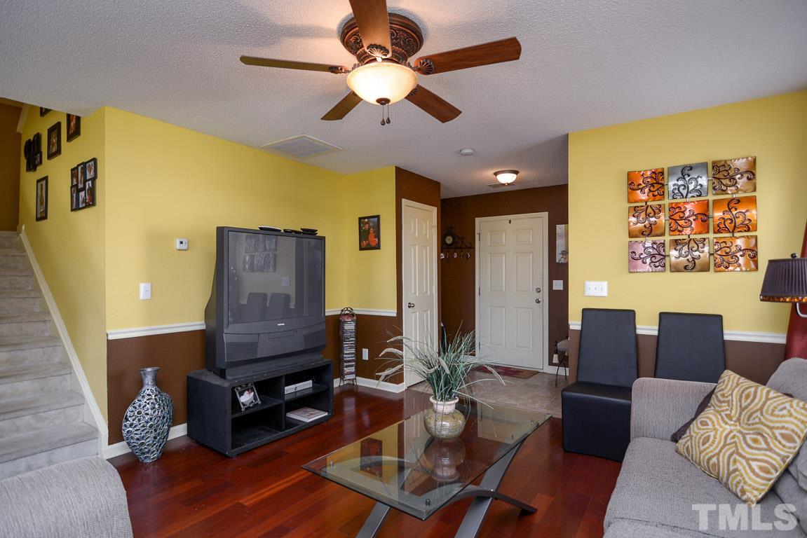3677 Marshlane Way Raleigh, NC 27610 - Photo 7 of 24 a living room with furniture and a flat screen tv