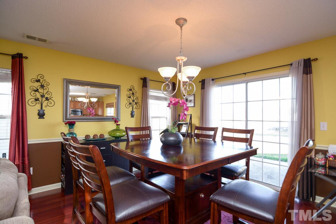 3677 Marshlane Way Raleigh, NC 27610 - Photo 8 of 24 a view of a dining room with furniture window and wooden floor