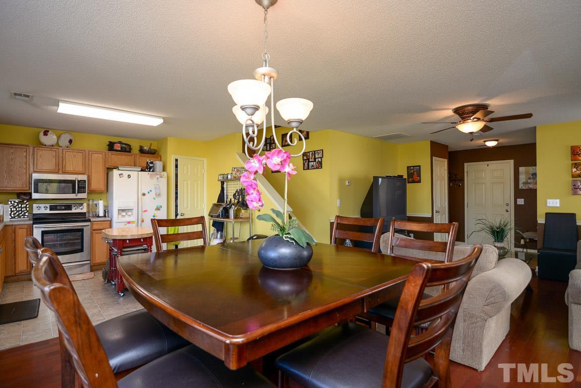 3677 Marshlane Way Raleigh, NC 27610 - Photo 10 of 24 a room with table chairs and a chandelier