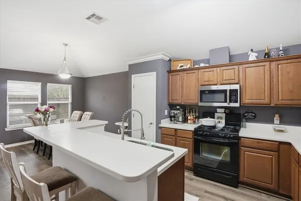 a kitchen with a stove a sink and a refrigerator