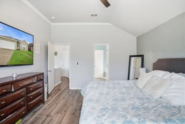 a bedroom with a bed and a flat screen tv